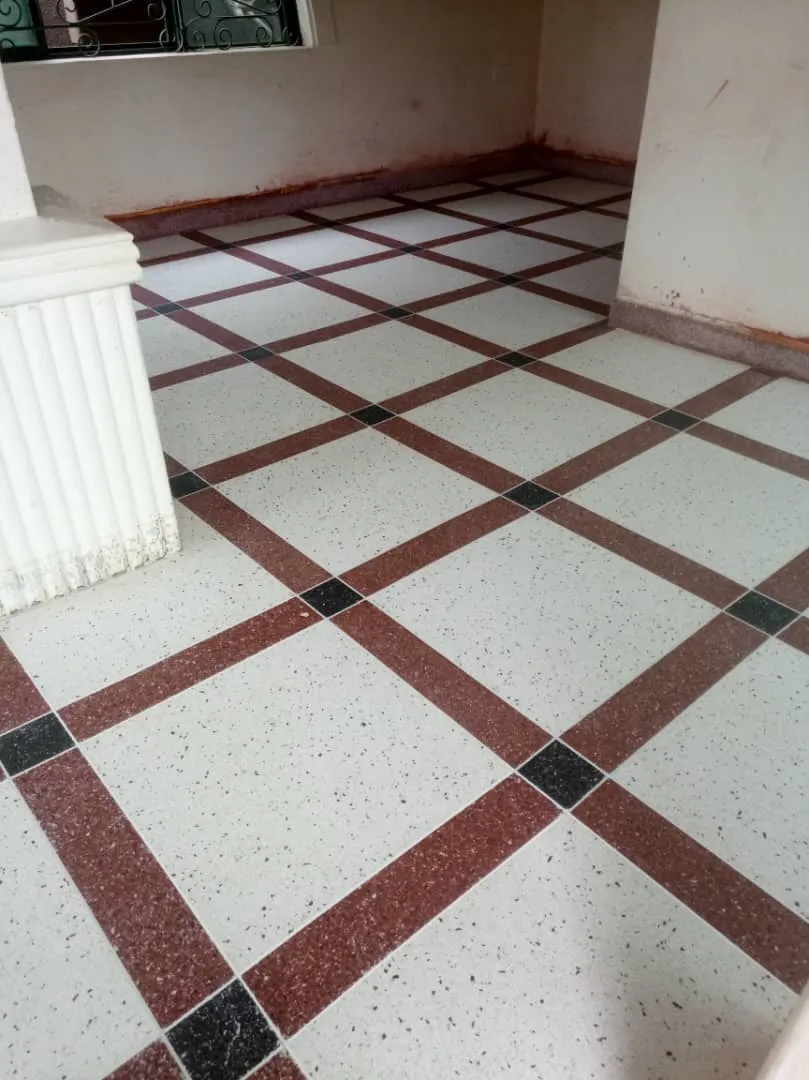 Terrazzo floor with red diamond bands and black squares