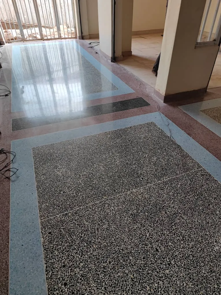 Terrazzo floor with grey border and dark speckled panel