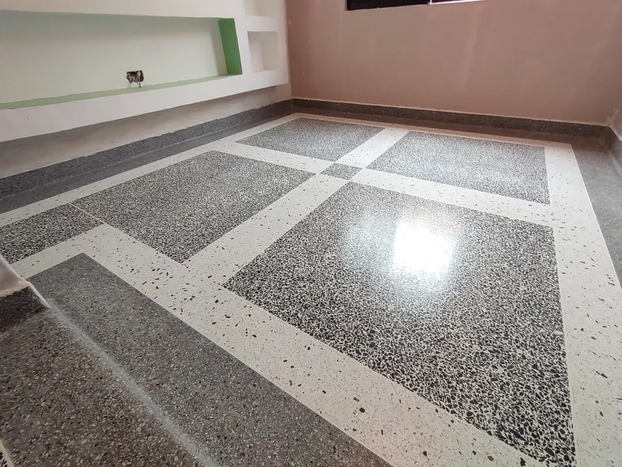 Patterned terrazzo floor with white bands in a private home